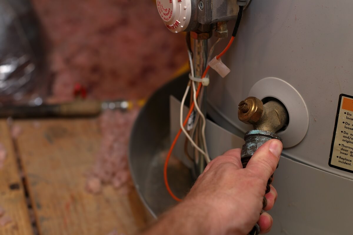 Water being released from hot water tank as part of servicing and replacement of hot water tank valves