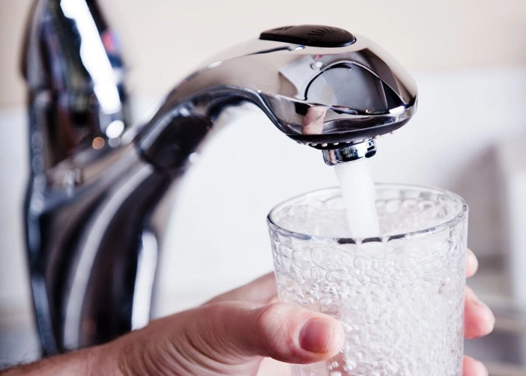 Filtered, chilled and sparkling water from all-in-one dispenser tap installed in kitchen
