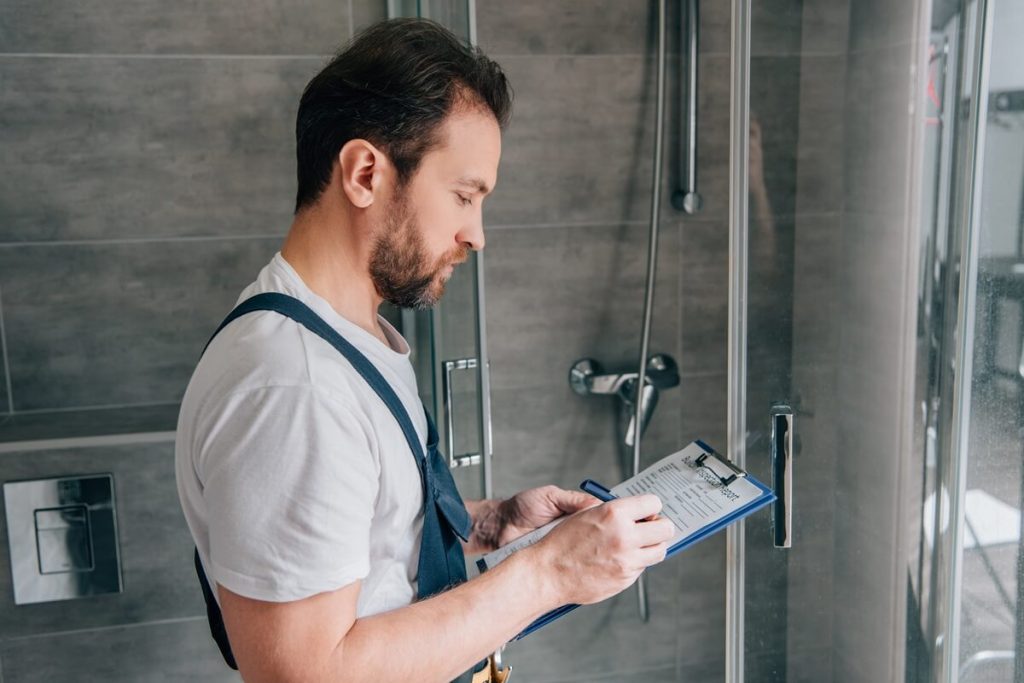 Plumber quoting on a leaking shower. Beware of plumber free quotes as the true cost can be higher than you think.