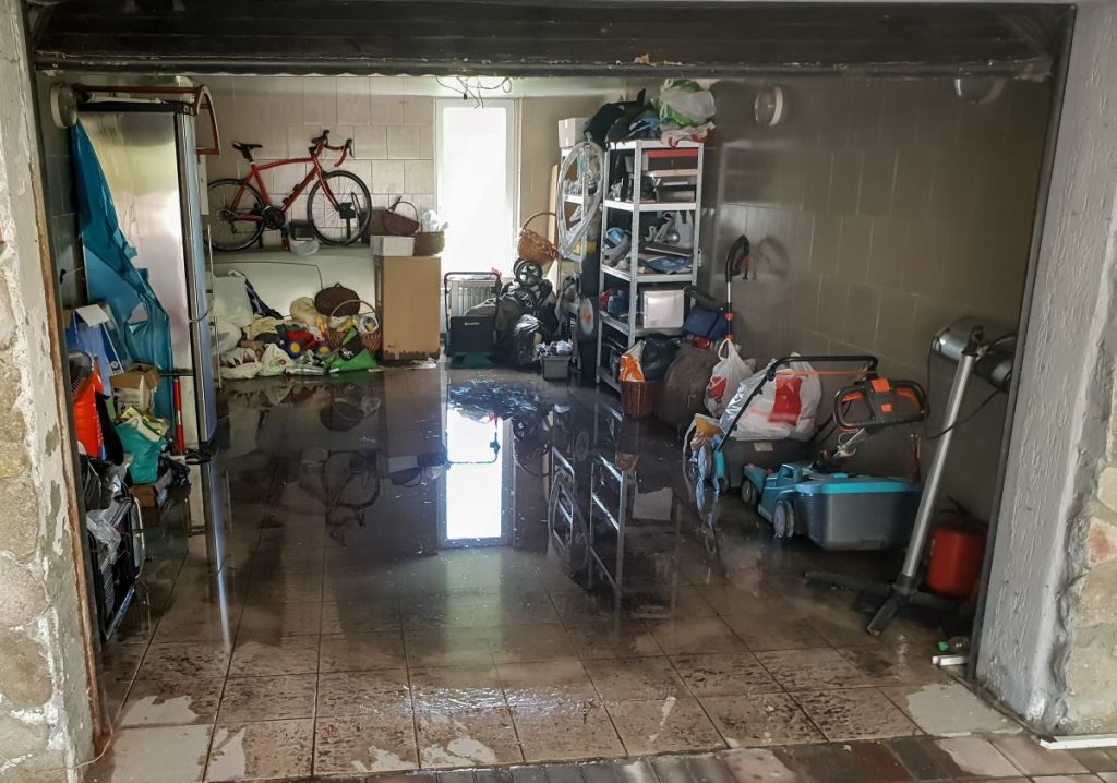 Flooded garage of home.  Talk to a plumber about the correct drainage Brisbane homes need to deal with wet summers and avoid flooding.