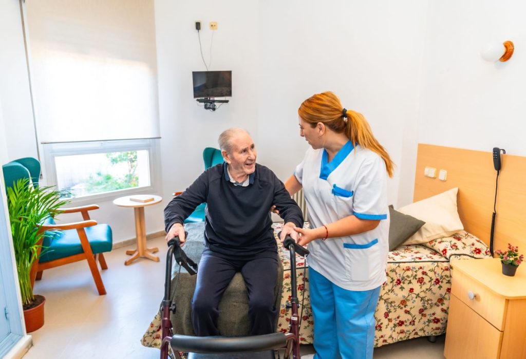 Nurse assisting patient in aged care facility. Reliable plumbing contractors for aged care facilities in Brisbane are critical for care