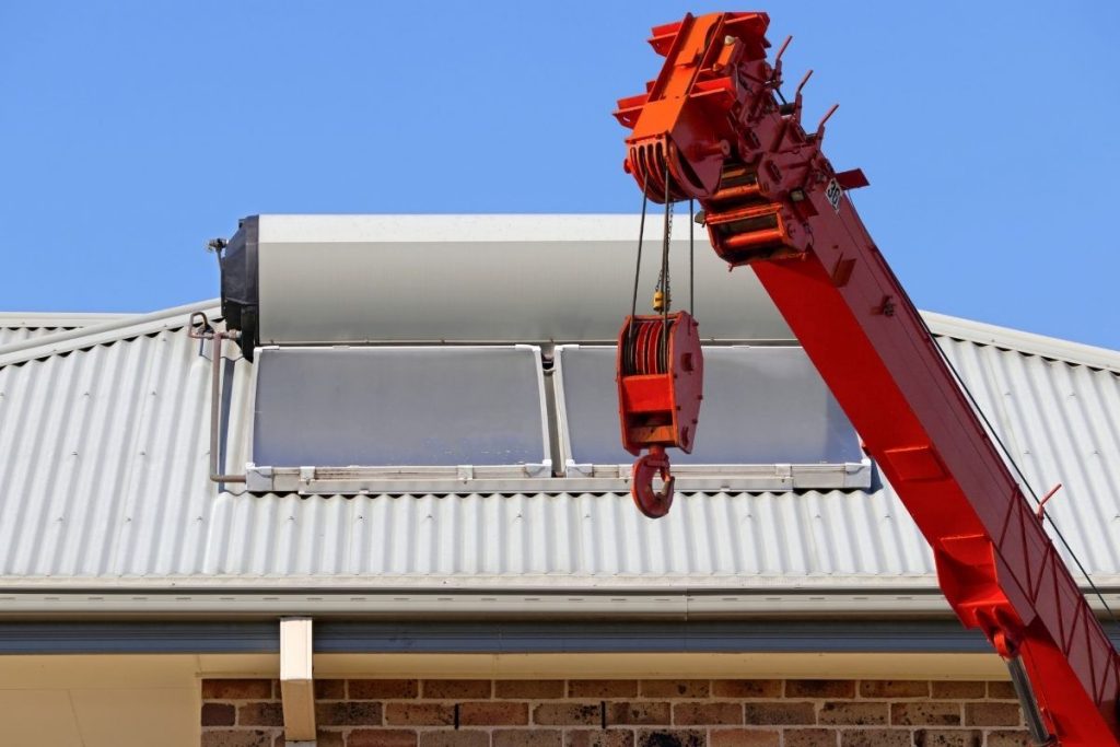 Hire a crane and plumbers from Salmon Plumbing for roof top solar hot water tank removal