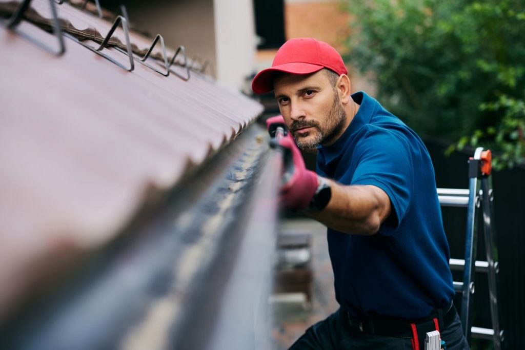 Inspecting and cleaning gutters in preparation for Brisbane storm season.